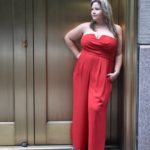 Plus Size model Sarah Hamel-Smith aka TheCurvyTrini is wearing a plus size red romper by @maree_pour_toi