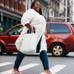 Plus size model Jezra Matthews (Jezra M) modeling plus size jeans and a plus size white top